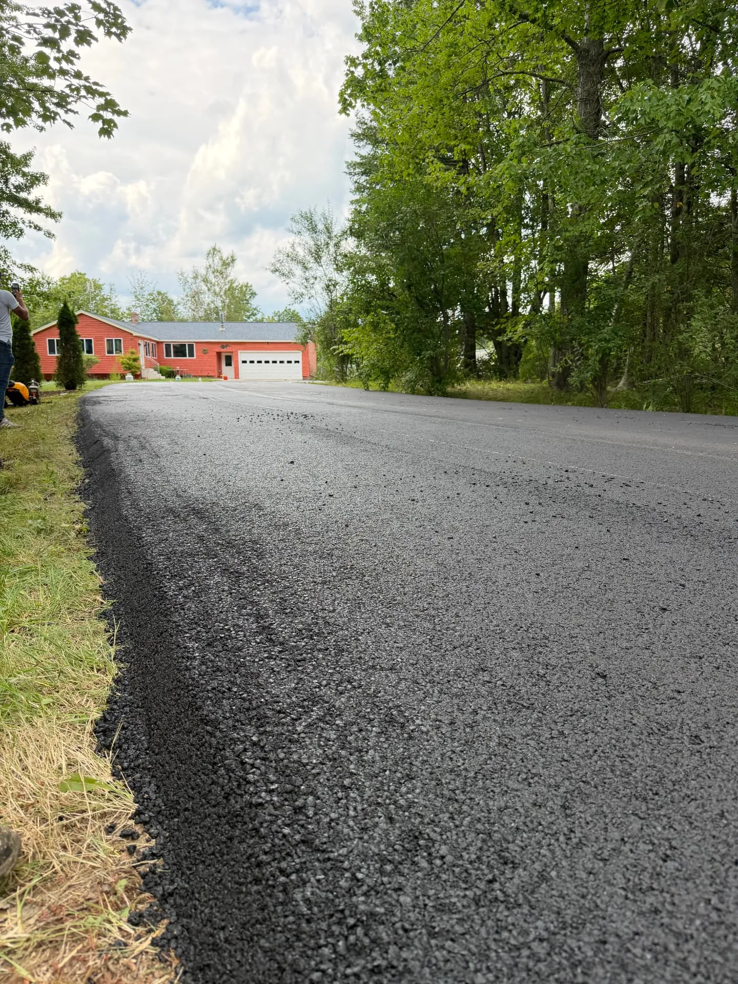 Close-up of a fresh asphalt edge on a long driveway