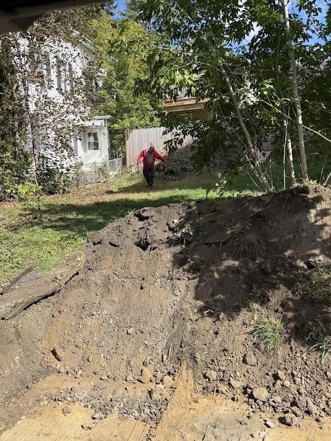 Excavated soil pile during site prep for a new driveway